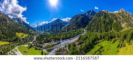 Panorama of a mountain valley. Blu sky with bright sun over mountain valley panoramic landscape Royalty-Free Stock Photo #2116587587