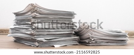 bundles bales of paper documents. stacks packs pile on the desk in the office. waste paper, paper trash Royalty-Free Stock Photo #2116592825