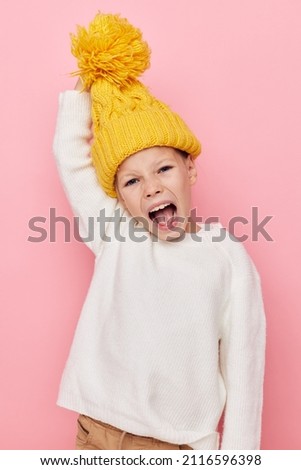 Portrait of happy smiling child girl fun in a yellow hat fun childhood unaltered
