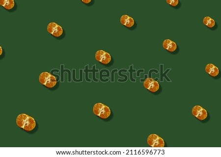 Colorful fruit pattern of fresh tangerines on green background with shadows. Mandarine. Top view. Flat lay. Pop art design