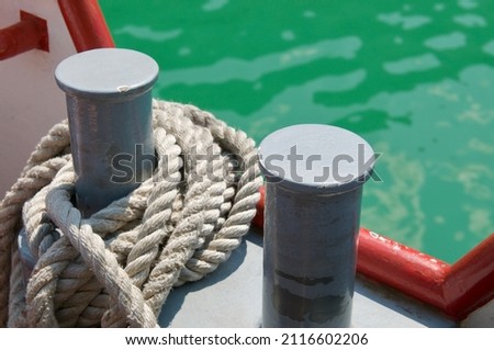 Close up picture of two bollards with mooring rope of a tourism boat on the lake Lugano, Switzerland