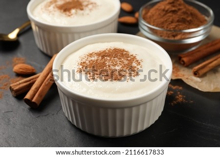 Delicious semolina pudding with cinnamon on black table Royalty-Free Stock Photo #2116617833