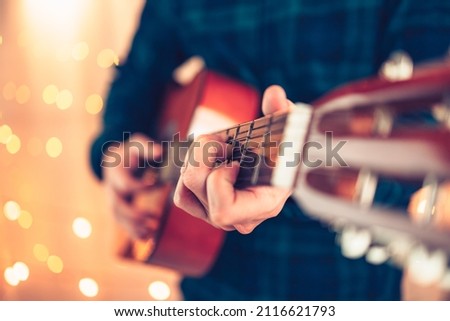 man's hands playing acoustic guitar, close up. Music concept.