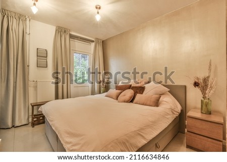 Beautiful bedroom in new luxury home with some decor Royalty-Free Stock Photo #2116634846