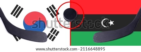 Top view hockey puck with South Korea vs. Libya command with the sticks on the flag. Concept hockey competitions