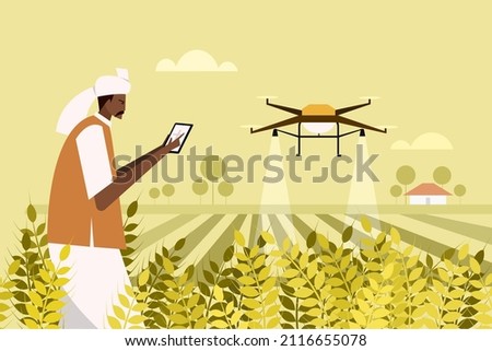 An Indian farmer using a drone for spraying fertiliser in the agricultural field Royalty-Free Stock Photo #2116655078