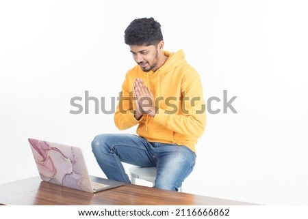 young man holding laptop and attending video calls