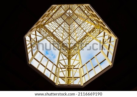 The octagonal shape of the steel building that peeps through from below is similar to the Eiffel Tower.