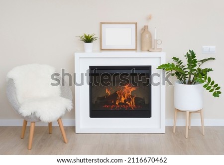 Fireplace with armchair and decoration in bright living room interior