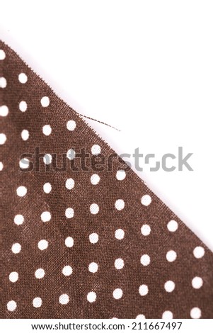 white dots in brown textile cloth