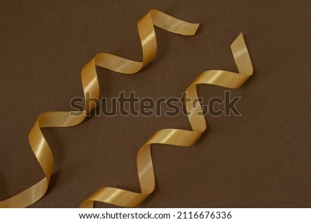 Image of a gift made of golden ribbon