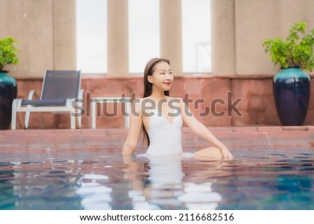 Portrait beautiful young asian woman relax smile leisure around outdoor swimming pool in hotel and resort