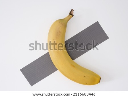 Concept "bananas are eaten, not taped", a funny reinterpretation of a very famous work of modern art. Royalty-Free Stock Photo #2116683446