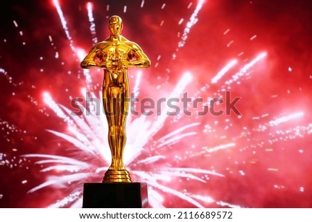 Hollywood Golden Oscar Academy award statue on fireworks background. Success and victory concept.