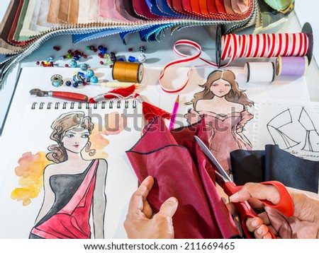 Fashion designer's hands working with material and hand-drawn illustration