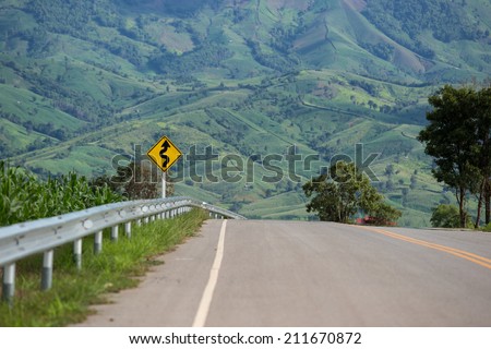 Road sing in rural area with mountain background