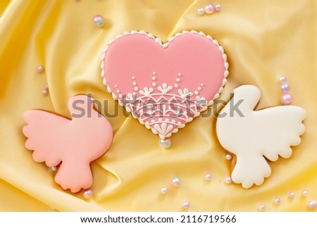 background banner greeting card for valentine's day with bouquet of pink tulips and heart gingerbread cookies on silk fabric background