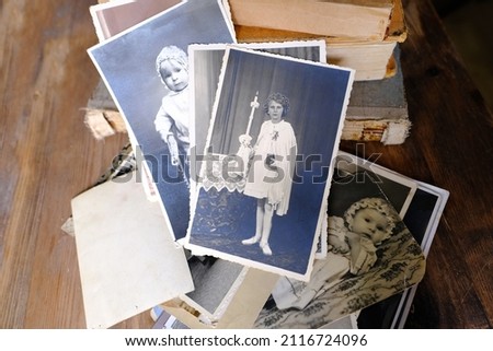 stack of vintage photos, retro photography of 1960 on wooden table, old books, concept of genealogy, memory of ancestors, family tree, genealogy, childhood memories, family archive