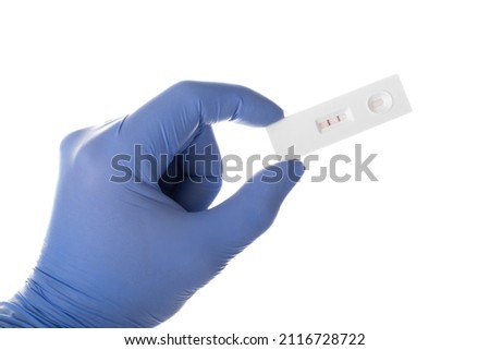 Hand in gloves hold a Positive PCR Antigen Rapid Test On white background. Testing for Sars Covid  Coronavirus during pandemic 