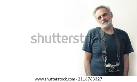 Man in his 40s posing with the film camera - copy space. High quality photo