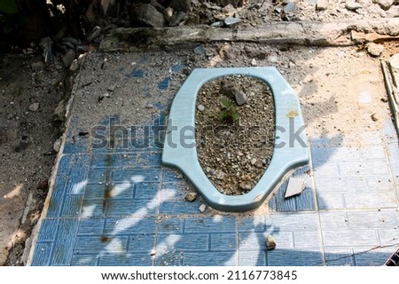 Unused squat toilet after the house collapsed