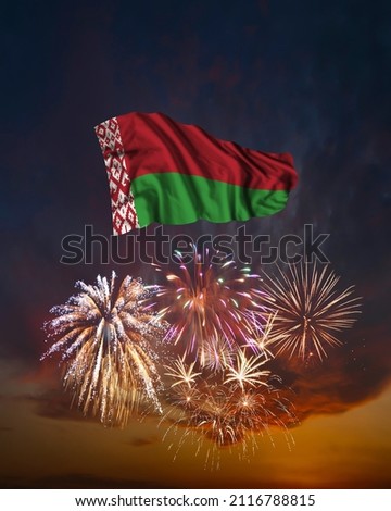 Holiday fireworks in evening sky and flag of Belarus for National Independence day