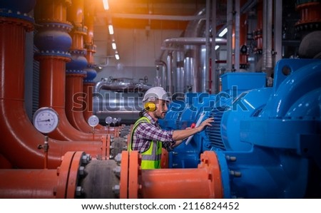 Industry engineer under checking the industry cooling tower air conditioner is water cooling tower air chiller HVAC of large industrial building to control air system. Royalty-Free Stock Photo #2116824452