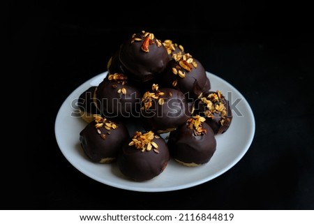 healthy protein candies in chocolate with peanuts and coconut on a black background
