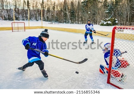 The hockey players play on winter season outside