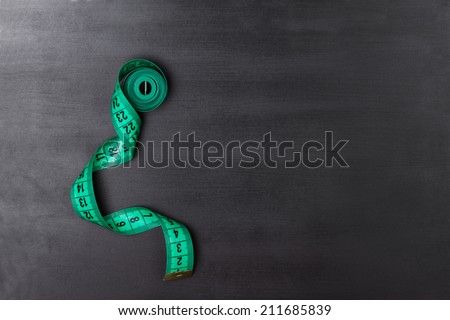 Chalkboard with a tailor measuring tape Royalty-Free Stock Photo #211685839