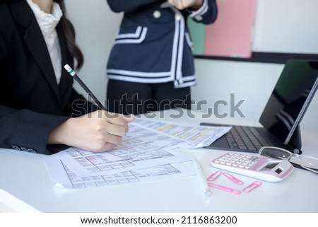 Business manager checking and signing filing documents reports papers company on desk office. Document Report and business Concept.