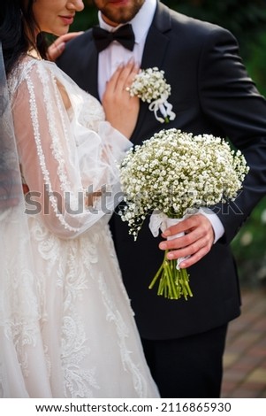 Wedding bouquet with fresh natural flowers in the hands of the bride