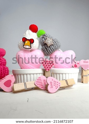 Background of Valentine’s Day. Candles, knitted hats and pins.