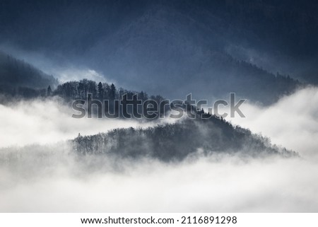 Misty fairytale mountainview of mountains shrouded in fog