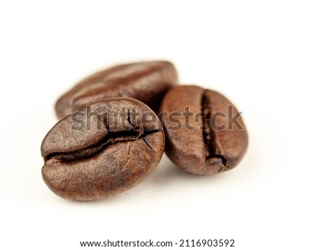Coffee beans are Robusta. On a white background. Robusta is praised for its high caffeine content, low sugar content and low acidity. Selective focus. Royalty-Free Stock Photo #2116903592