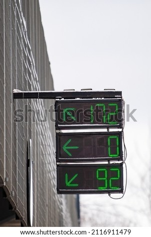Sign on the three-level parking with a digital display showing the number of available parking spaces