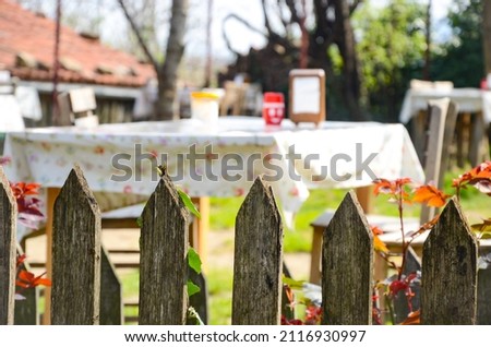 a lovely garden behind wooden fences 