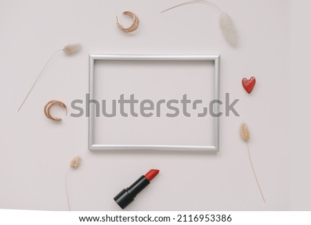 minimal fashion mockup with empty photo frame and red lipstick and women's accessories on white background