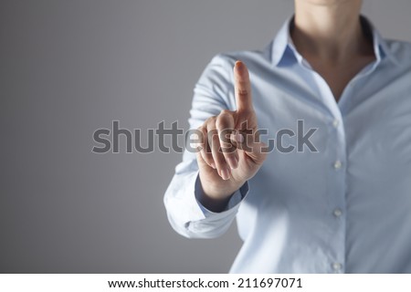 Businesswoman in front of visual touch screen. Royalty-Free Stock Photo #211697071