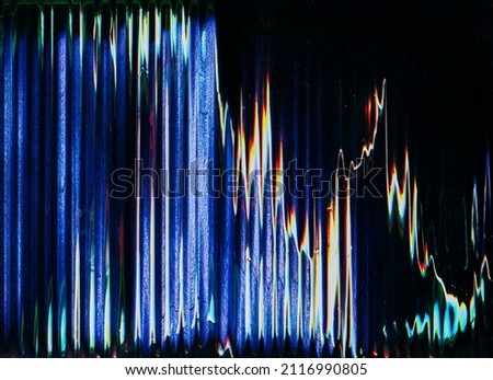 Glitch overlay. Digital noise texture. Frequency error. Distressed display. Blue orange fuzzy artifact defect on dark black abstract background.
