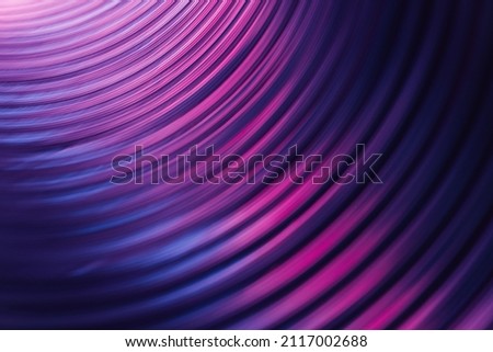 Fluorescent background. Blur curved texture. Futuristic light. Defocused neon pink purple blue color gradient glow on dark ridged abstract overlay. Royalty-Free Stock Photo #2117002688