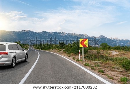 Car on a scenic road. Car on the road surrounded by a magnificent natural landscape.