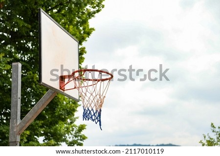 basketball hoop and net on the background of blue sky with negative space