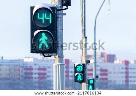 Three traffic lights for pedestrians show the time left to cross the road. High quality photo Royalty-Free Stock Photo #2117016104