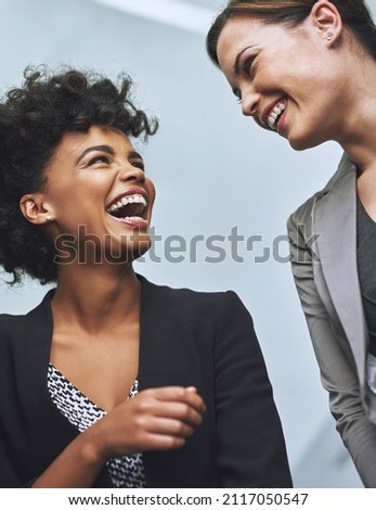Building positive business relationships. Shot of colleagues laughing together in an office. Royalty-Free Stock Photo #2117050547
