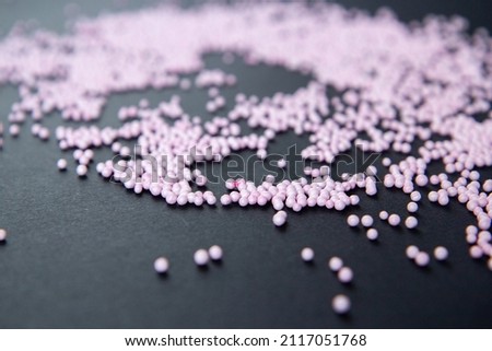 pink foam balls on black background