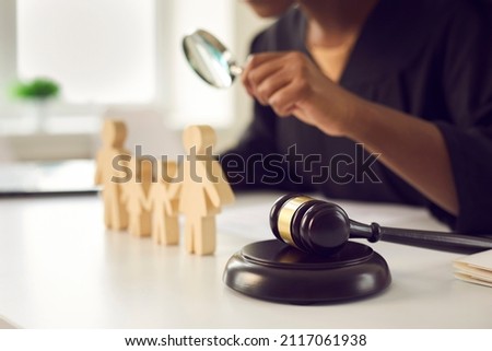 Crop close up of gavel on table of lawyer deal with family or matrimonial law. Juror with magnifier work with domestic relations cases in courthouse. Legislation and jurisdiction concept. Royalty-Free Stock Photo #2117061938