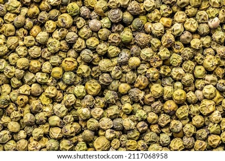 Dried green peppercorn. Dry green pepper spice. Top view. Royalty-Free Stock Photo #2117068958