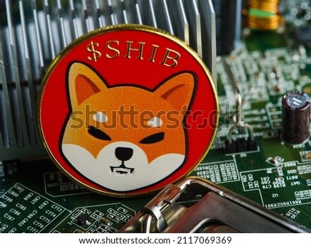 A popular cryptocurrency is a Shiba Inu coin on the motherboard of a personal computer. Crypto farm, mining, new financial and computer technologies, small business, virtual electronic money.
