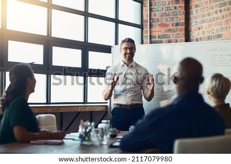This is our target market. Cropped shot of a mature businessman giving a presentation in the boardroom. Royalty-Free Stock Photo #2117079980
